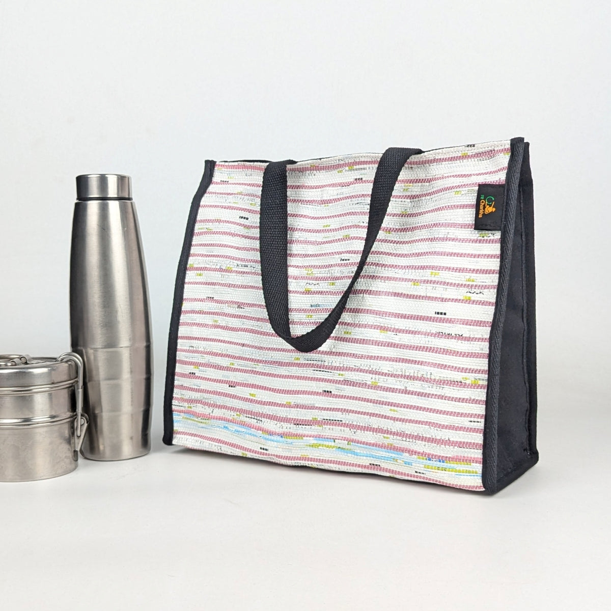 Striped lunch bag with black handles and trim,